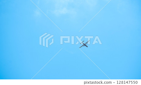 A small airplane flying in the blue sky A small airplane flying in the blue sky 128147550