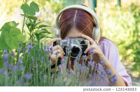 Young photographer capturing nature with headphones 128148083