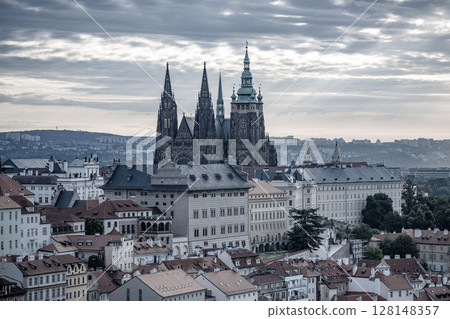 The early morning sun casts a golden hue over Prague Castle, illuminating its towers and highlighting the historic architecture of the city. A perfect start to the day in Prague. The early morning sun casts a golden hue over Prague Castle, illuminating its towers and highlighting the historic architecture of the city. A perfect start to the day in Prague. 128148357