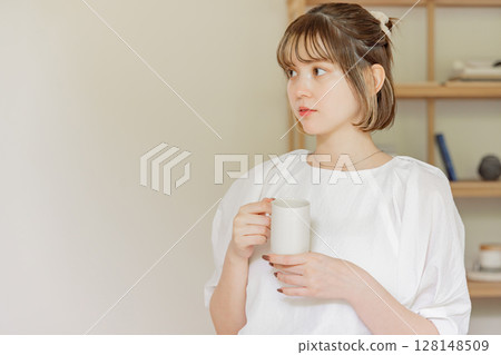A woman with a mug A woman with a mug 128148509