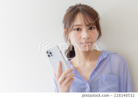 Young woman using a smartphone 128148532