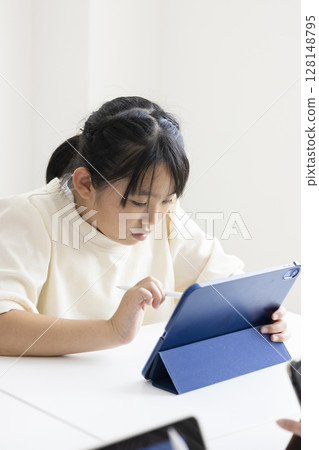 Elementary school students using tablets Elementary school students using tablets 128148795