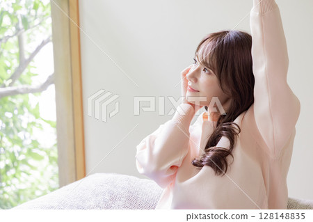 Woman stretching on the sofa Woman stretching on the sofa 128148835