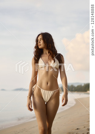 Beautiful body woman on the beach. Sexy girl in Bikini at sunset time 128148888