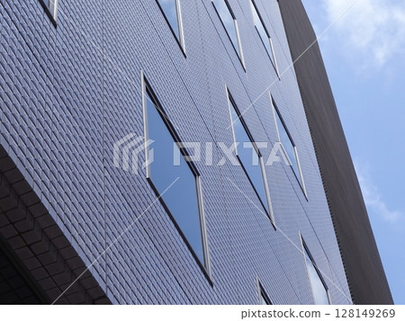A glass-enclosed building that shines in the blue sky A glass-enclosed building that shines in the blue sky 128149269