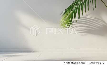 minimalistic background with blurred foliage shadow on white wall and palm leaves minimalistic background with blurred foliage shadow on white wall and palm leaves 128149317