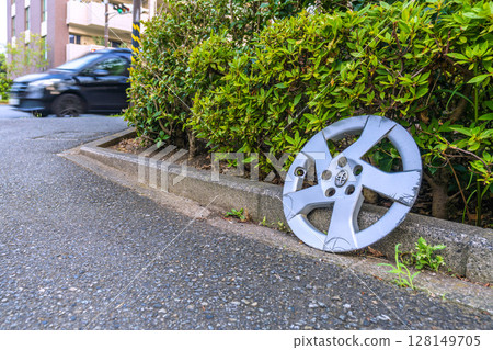 Yokohama cityscape in Japan: A lost aluminum wheel... Why is it on the side of the road where cars pass by, on the side of the sidewalk... (*not staged) Yokohama cityscape in Japan: A lost aluminum wheel... Why is it on the side of the road where cars pass by, on the side of the sidewalk... (*not staged) 128149705