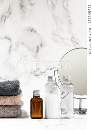 Skin care image with towels and cosmetics on a marble background Skin care image with towels and cosmetics on a marble background 128149721