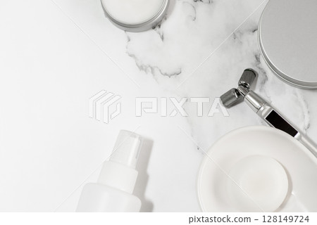 Cosmetics and beauty devices arranged on marble Cosmetics and beauty devices arranged on marble 128149724