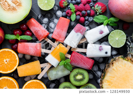 Colorful ice cream pops made with various berries are placed flat on a stylish surface. Surrounding them are fresh fruits like kiwi, oranges, and melons, enhancing the summer vibe. Colorful ice cream pops made with various berries are placed flat on a stylish surface. Surrounding them are fresh fruits like kiwi, oranges, and melons, enhancing the summer vibe. 128149930