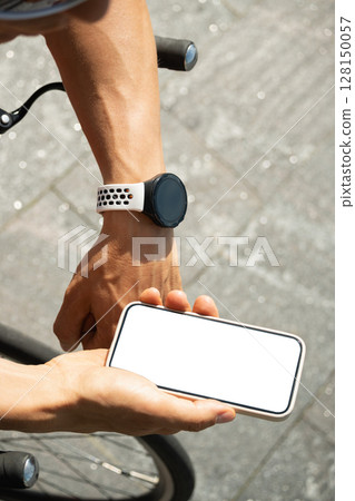 Athlete cyclist checking geolocation, timer, distance, pulse or fitness progress in apps after riding. Close up man hands checking his heartbeat with smartwatch. Summer activity. Athlete cyclist checking geolocation, timer, distance, pulse or fitness progress in apps after riding. Close up man hands checking his heartbeat with smartwatch. Summer activity. 128150057