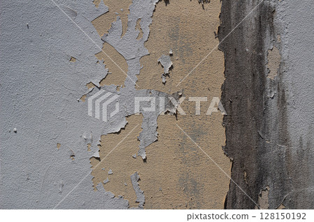 Detail of old weathered concrete wall with peeling paint and dark stain 128150192