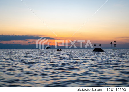 Boat at sunset on Lake Tempe, Sulawesi, Indonesia 128150590