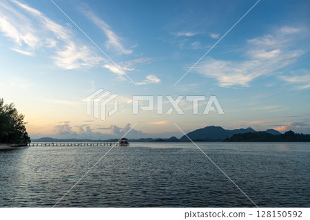 Sunset view of pier on Bolilanga Island, Togian archipelago, Sulawesi, Indonesia 128150592