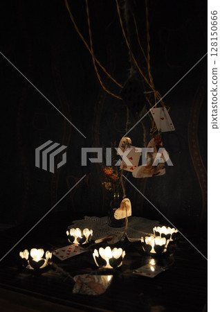 Vintage still life with candles in darkness and playing cards 128150666