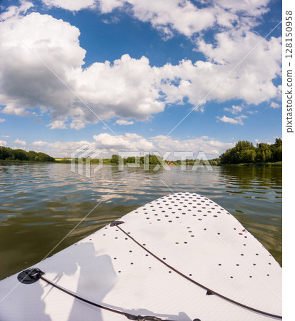 Paddleboarding on a Serene Lake Paddleboarding on a Serene Lake 128150958