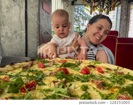 Mother and Baby Enjoying Pizza at a Restaurant 128151003