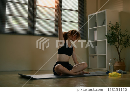 Female athlete in sportswear practicing yoga at home on a mat. Healthy lifestyle concept Female athlete in sportswear practicing yoga at home on a mat. Healthy lifestyle concept 128151150