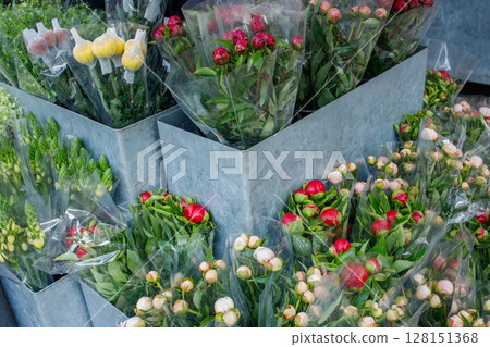 Fresh peonies packed for sell. Multicolored spring flowers bouquets sold right on the street. Fresh peonies packed for sell. Multicolored spring flowers bouquets sold right on the street. 128151368