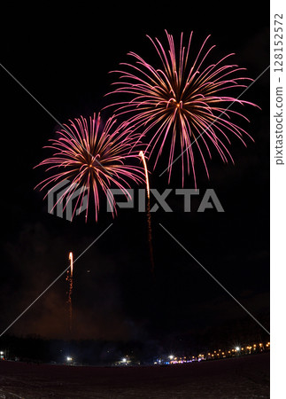 Fireworks launched from the snow in a park in Hokkaido with the moon, Venus, and Saturn in the background 128152572