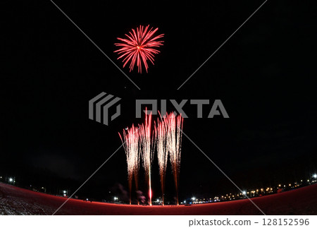 Fireworks launched from the snow in a park in Hokkaido with the moon, Venus, and Saturn in the background 128152596