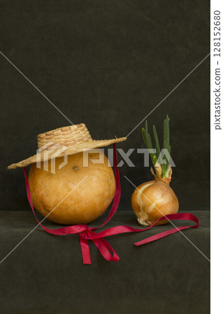 Still life with pumpkin, hat and sprouted onions 128152680