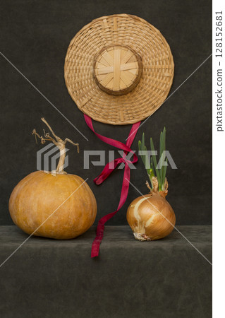 Still life with pumpkin, hat and sprouted onions 128152681