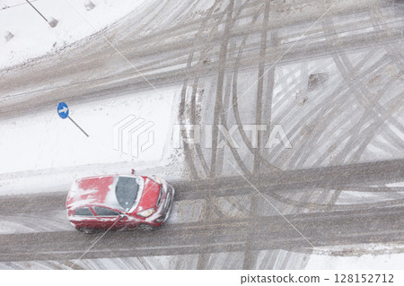 Car on road covered with snow 128152712