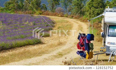 Clothes hanging to dry outdoors by camping car. Caravan vacation in France Clothes hanging to dry outdoors by camping car. Caravan vacation in France 128152752