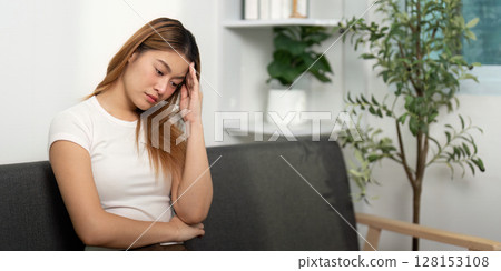 Mental Health: Young woman with a pensive expression, showing signs of stress. 128153108