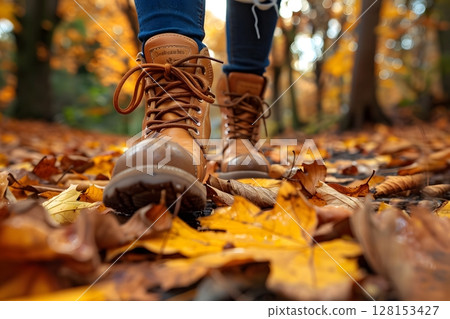 Close-Up of Boots Stepping in Crunchy Leaves. Autumn 128153427