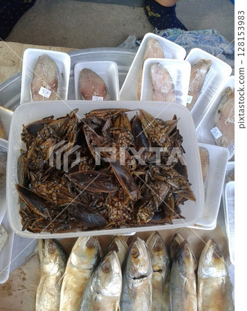 Fresh Seafood and Insects Displayed at a Bustling Outdoor Market with Labeled Prices 128153983