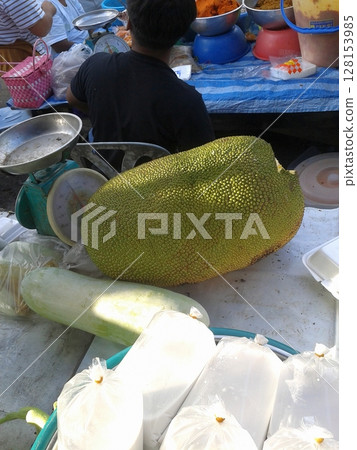 Tropical Fruit and Fresh Produce Market with Jackfruit, Daikon, and Packaged Items on Display 128153985