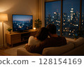 young man watching tv at home 128154169