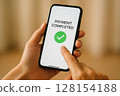 Hand holding smartphone with Payment Completed 128154188