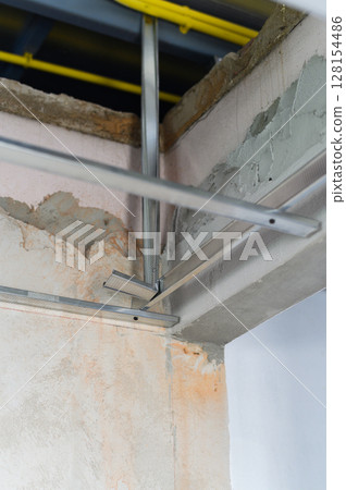 Sturdy aluminum framework provides essential framing for interior renovation project, showcasing diligent construction effort toward progress 128154486