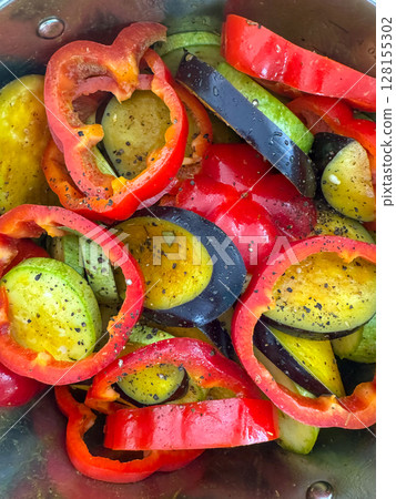 Colorful vegetables prepared for roasting in a stainless steel bowl 128155302