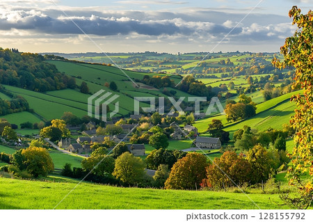 Picturesque Autumnal Village nestled in Rolling Green Hills. Picturesque Autumnal Village nestled in Rolling Green Hills. 128155792