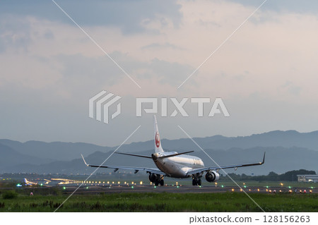 Sendai Airport at dusk, airplane taking off, Natori City, Miyagi Prefecture Sendai Airport at dusk, airplane taking off, Natori City, Miyagi Prefecture 128156263