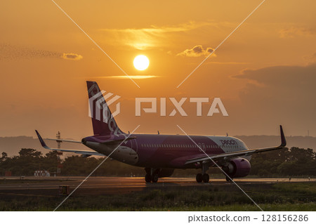 Sendai Airport at dusk, plane taxiing, Natori City, Miyagi Prefecture 128156286