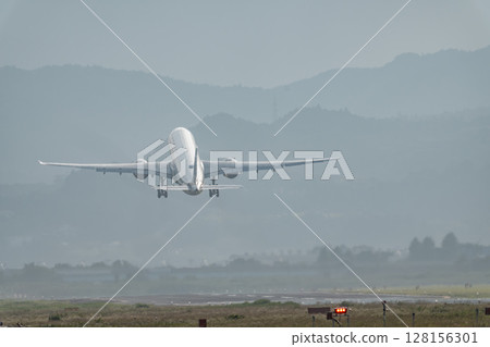 Sendai Airport at dusk, airplane taking off, Natori City, Miyagi Prefecture Sendai Airport at dusk, airplane taking off, Natori City, Miyagi Prefecture 128156301