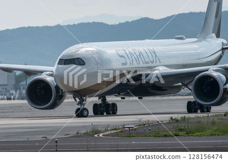 Sendai Airport at dusk, plane taxiing, Natori City, Miyagi Prefecture 128156474