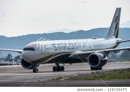 Sendai Airport at dusk, plane taxiing, Natori City, Miyagi Prefecture 128156475
