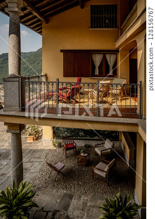 Elegant Italian Courtyard With Traditional Architecture: Cozy Outdoor Lounge And Balcony In A Lombardy Villa 128156767