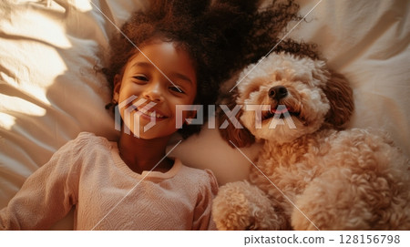 Girl and Dog Cuddle on Bed Girl and Dog Cuddle on Bed 128156798