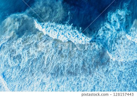 Ocean surf. Waves roll onto the shore. View from above. Natural abstract background 128157443