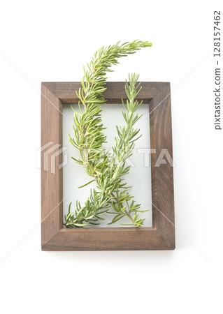 Wooden picture frame and rosemary leaves photographed on white background 128157462