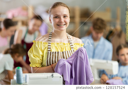 Teen girl child with cloth in hands 128157524