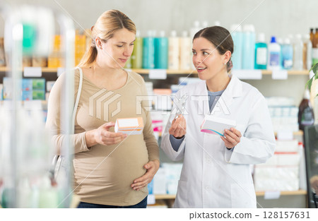 Pharmacist consulting pregnant woman on medication safety Pharmacist consulting pregnant woman on medication safety 128157631