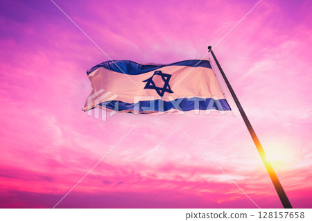 Flag of Israel fluttering against pink sunset sky 128157658